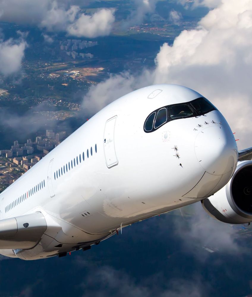 commercial-aircraft-climbing-over-city-in-flight-shutterstock-523950889 (1).jpg